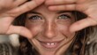 © VictorCanalesStudio - Portrait of a smiling young woman with freckles making a heart shape with her hands