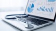 © Дмитрий Баронин - Stethoscope resting on a laptop displaying health data charts and graphs, symbolizing the integration of technology in healthcare and medical analysis for improved patient outcomes