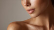 © PhotoLuxeStudio - Close up of female face and shoulder with natural skin texture and gentle expression under soft lighting