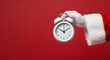 © Syed - Santa Claus Holding an Alarm Clock on Red Background.