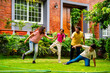© StockImageFactory - Indian family playing Langdi or one-leg hop game in garden, enjoying energetic outdoor fun