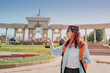 © EdNurg - Young woman in traditional skullcap enjoying a sunny day in Almaty, Kazakhstan