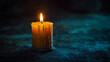 © KotBaton - Halloween, one burning candle in a vintage candlestick, dark gloomy background, minimalistic place for text.