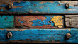 © Tut Mandi - Close-up of multicolored, weathered wooden planks with metal fasteners.