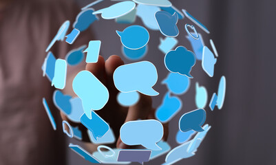 Abstract image of a hand holding a sphere of digital speech bubbles, representing global communication and networking.