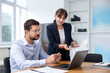 © New Africa - Consultant working with client at table in office. Business meeting
