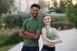 © New Africa - Smiling runners posing with crossed arms outdoors
