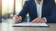 © Anousone - Financial planner with a client, pointing to a section of a document, clear explanation
