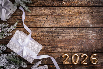 Wall Mural - rustic christmas background with gift boxes tied with white ribbon and snow fir branches on vintage 