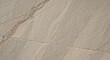 © Ayrus.std - Close-up view of a light gray stone or tile surface with golden veins