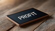 © FocusFusion - Tablet Displaying Profit on Wooden Table Surface