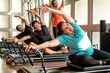 © Luis Herrera/Stocksy - Diverse Group Enjoying Pilates Class