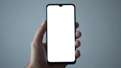 Man holding smartphone with blank white screen, ready for creative content integration and app demonstration.