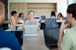 © Santi Nuñez/Stocksy - Senior businesswoman leading a diverse team meeting in modern office