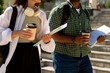 © Danil Nevsky/Stocksy - University students walking, holding books and coffee, back to school