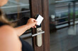 © mahalo studio/Stocksy - Businesswoman opening office door with electronic keycard