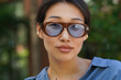 © Roman Shalenkin/Stocksy - Close-up portrait of young asian girl with glasses