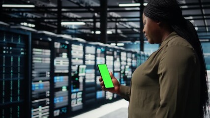 Employee using app on mockup mobile phone to check server hub energy consumption. Data center engineer using application on isolated screen smartphone to check power usage levels, camera A