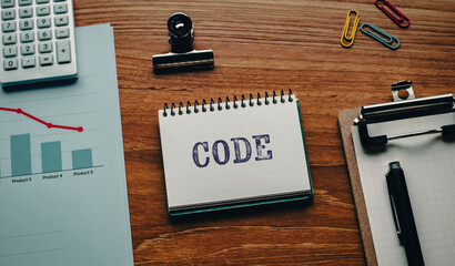 There is notebook with the word CODE. It is as an eye-catching image.