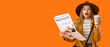 © Pixel-Shot - Shocked young woman with newspaper and coffee cup on orange background