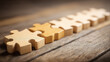 © Benjamin - Row of wooden puzzle pieces assembled in sequence illustrating process steps workflow planning and building a strong foundation for projects