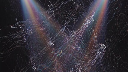 Wall Mural - A multi-colored spotlight effect illuminates an intricate tapestry of shifting light threads in a seamlessly looping video flow, dynamic, smooth