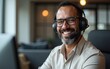 © handong - Happy senior latin Hispanic man in wearing headphones, helping as callcenter consult assistant. Smiling mature 40s years old mixed race businessman holding video call with clients partners. Copy space