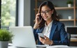 © li - Young Asian business woman manager ceo using cellphone mobile phone, laptop computer. Smiling mature female businesswoman holding smartphone in office for trading, working, chatting online. Copy space
