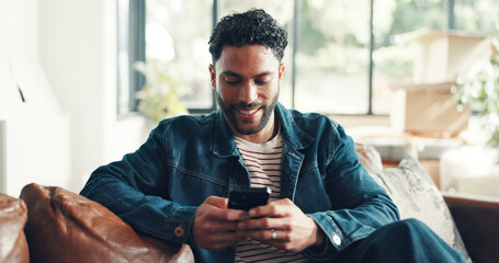 Happy, texting and man in home with phone, doom scrolling and funny chat on app. Social media, meme and Asian male in living room with mobile, virtual game or online communication in message update.