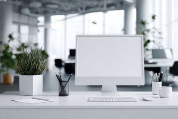 blurred background of a modern office interior with a white desk and computer monitor mockup, a minimalist work space for a graphic designer or web developer, with copy space.