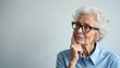© Pete - Elderly woman with glasses ponders solution. Mature female expression shows curiosity, thought process. Cognition, wisdom, contemplation evident in thoughtful gesture, serious look. Appears to