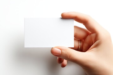 a hand holds a blank white business card (1)