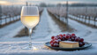 © Lastwizard Shop - wine and dessert pairing A glass of white wine alongside cheese and grapes in a snowy vineyard setting.
