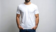 © Idah - Man modeling a plain white t-shirt, hands in pockets, against a neutral background.