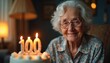 © Pete - Elderly woman with glasses smiles warmly, celebrating 100th birthday with cake adorned with lit candles. Warm lamp light illuminates serene face, grey hair, peaceful moment of life achievement,