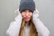 © mimagephotos - Playful woman in beanie making funny face