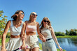 © Georgii - Group of young women enjoying a sunny day near a scenic waterway