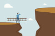 © vector - Solution to solve problem, businessman holds ladder that is to be climbed up to higher cliff