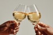© rifai_art - Two hands raise fluted glassware, filled with bubbly liquid, in a celebratory toast