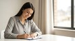 © yusup - Woman Writing in a Notebook.