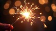 © JxS Creativity - Sparkler Celebration with Golden Sparks and Bokeh Lights in Dark Background