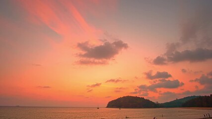 Wall Mural - Time lapse A peaceful tropical comes alive with color as the sun sets, offering a perfect moment of serenity and beauty. Vibrant Colors of a Tropical Evening at Kala island Layan beach Phuket