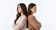 © Poetra RH - Two women, sisters or friends, with their backs to each other and arms crossed, depicting conflict, misunderstanding, and broken relationships. Perfect for themes of disagreement, sadness, and tension