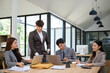 © wattana - Business professionals collaborating on a project in a bright office.