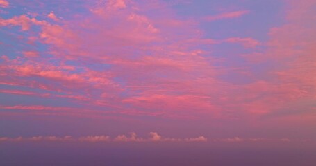 Wall Mural - Aerial view of pink sky above the island. bird eye view captures the beauty of the pink sky as it slowly changes from a light pink to a deep, vibrant hue. sweet sky background. sweet morning sunrise.