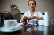 © Taras Grebinets - Woman Performing At-Home Manicure with Mirror and Beauty Products
