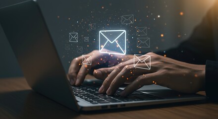 Hands typing on laptop keyboard with glowing digital envelope sending email technology concept