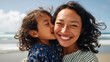 © Z A C - Woman hugging child at beach.
