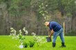 © Volodymyr - Gardener farmer working in spring garden. Gardener in garden with shovel. Mature gardener cultivating land. Mature farmer in orchard. Worker gardener planting seedling. Growing plants in backyard.