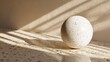 © Vectune - Speckled sphere casting a shadow on a terrazzo surface with sunlight streaming through window blinds creating a pattern